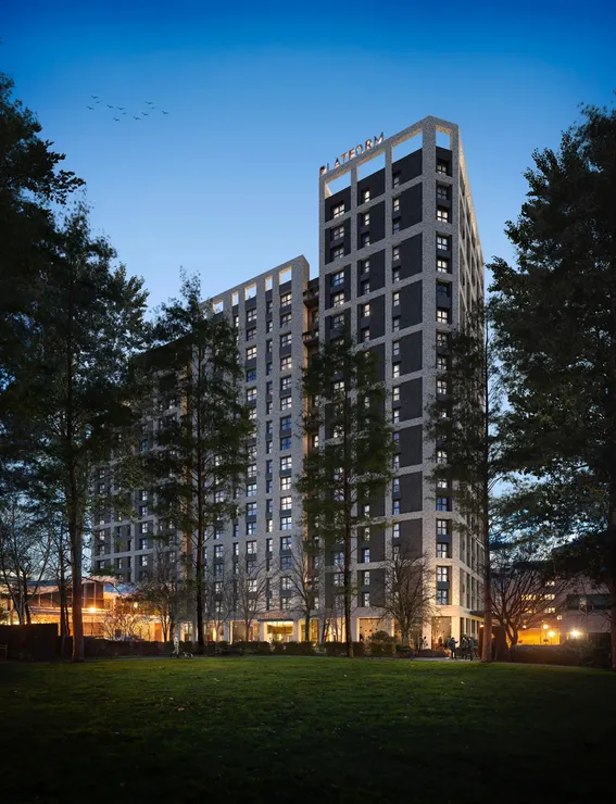 External CGI of apartment building at night across green space