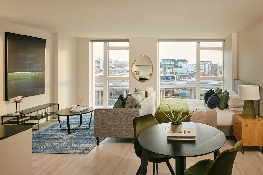Studio apartment showing double bed and sofa