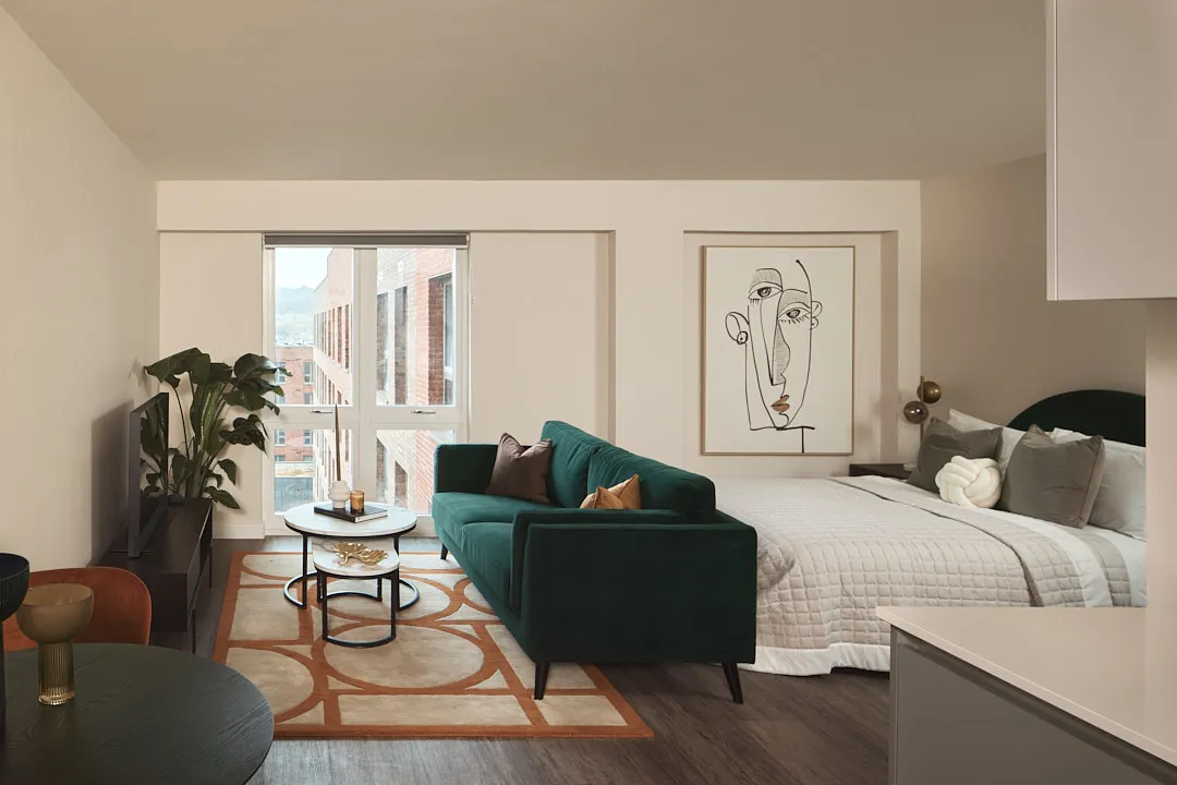 Studio apartment showing double bed and sofa