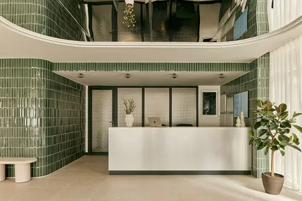 Reception area showing metal reception desk and tiled walls