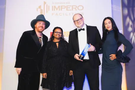 Team collecting an award on stage