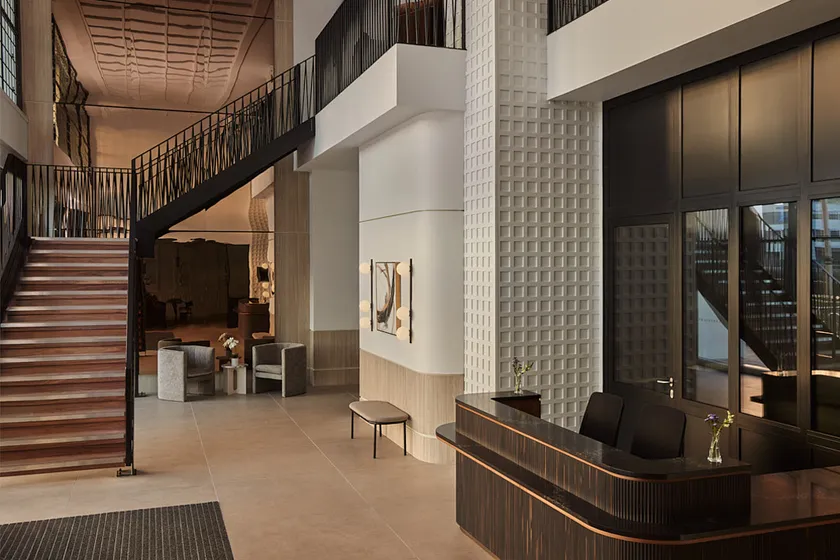 Double height reception area showing lobby desk and staircase