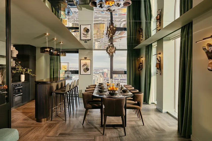 private dining room with 10 seater table and bar / kitchen area